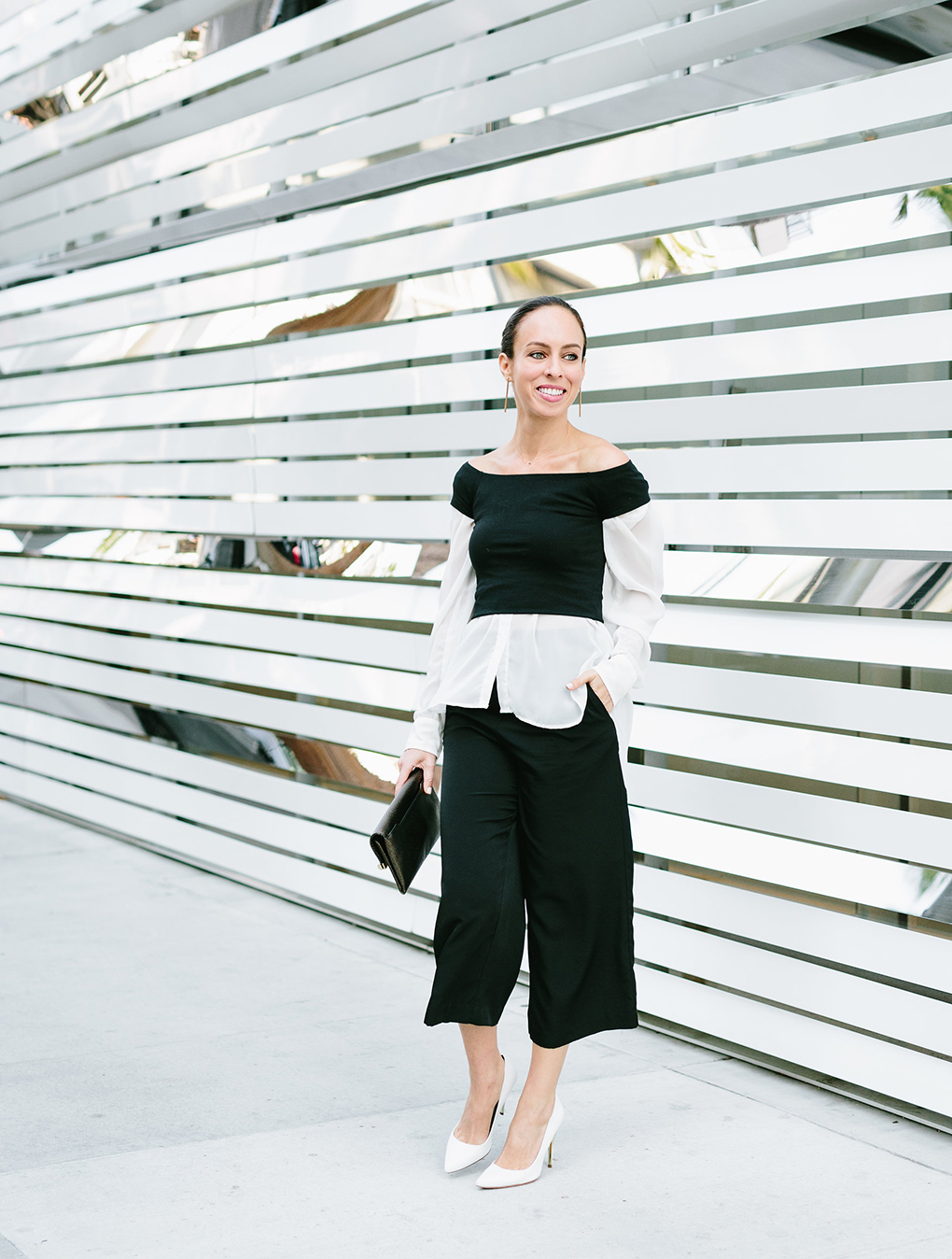 Sydne Style shows how to wear a crop top for fall with button down shirt and culottes white pumps