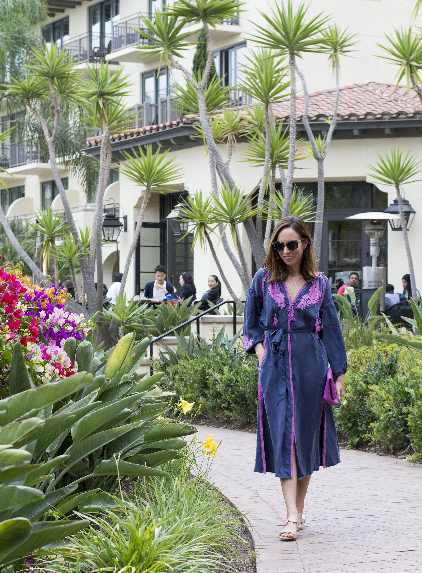Sydne Style shows what to wear on a resort vacation in line and dot kaftan