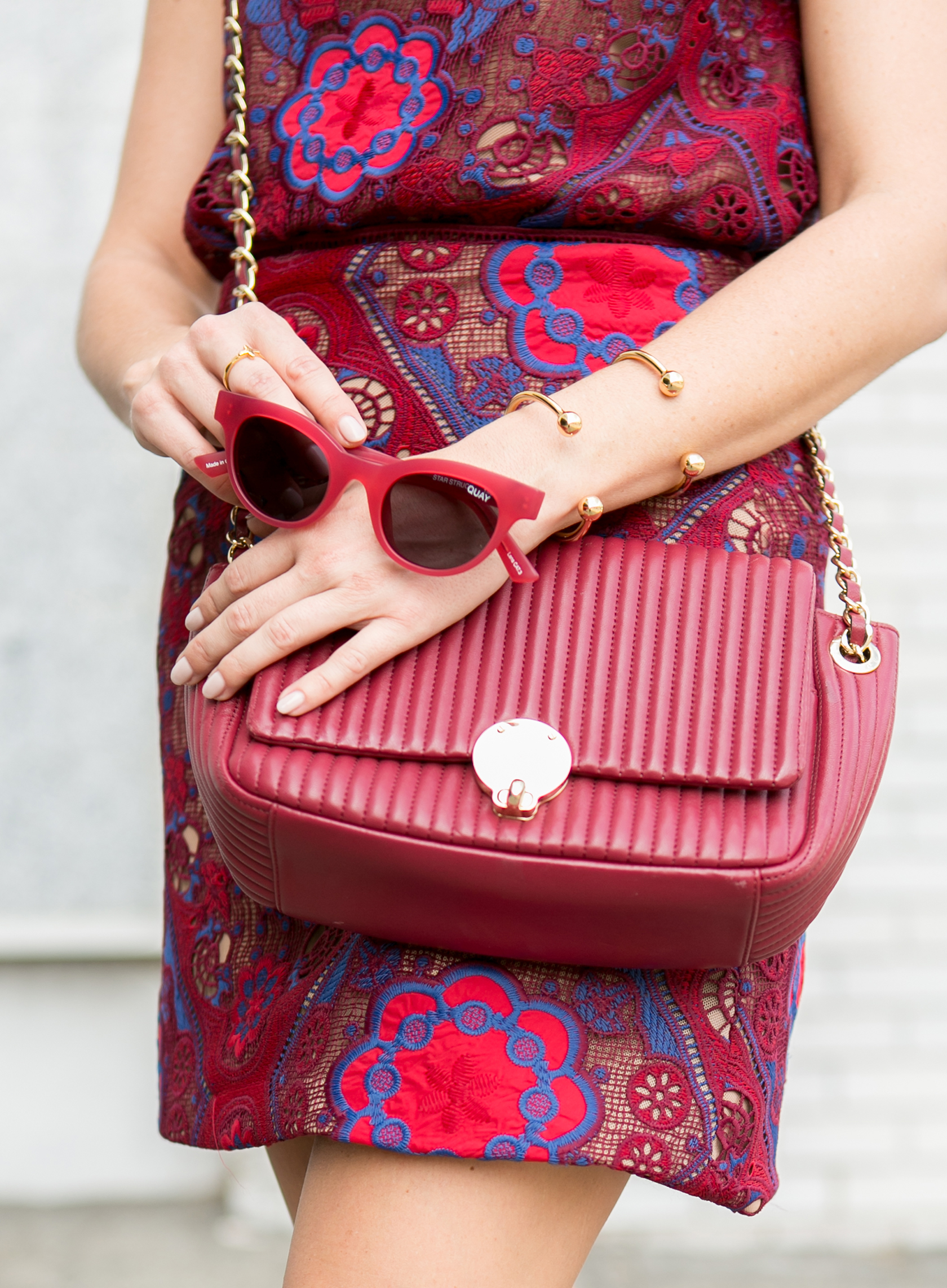 Sydne Style wears Henri Bendel burgundy bag