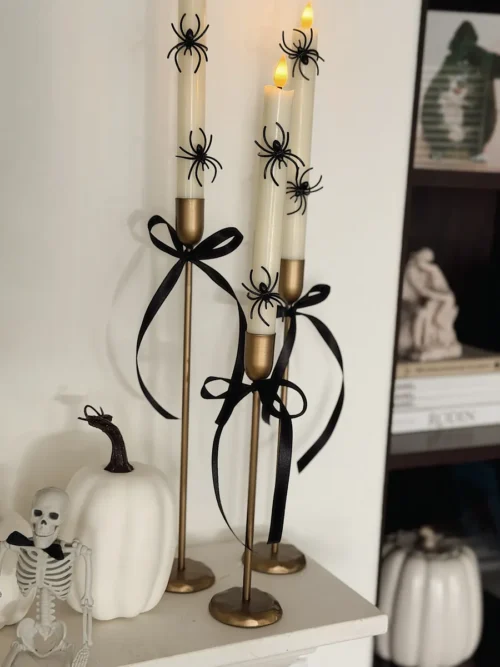 Gold candlesticks with black ribbon and spider rings for Halloween