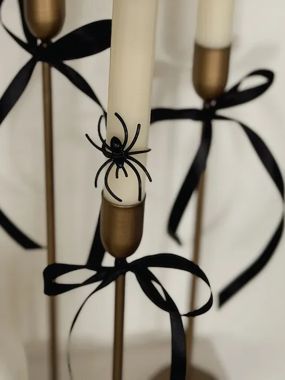 Plastic spider rings on flameless taper candles, five-minute Halloween DIY